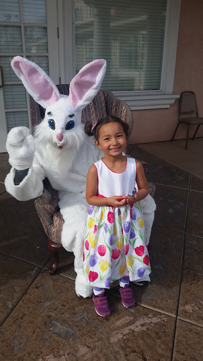 A young guest posing with the Easter Bunny