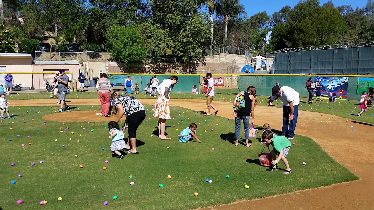 Children and families gathering Easter eggs on the ballfield