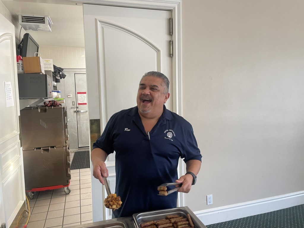 Vista Optimist Club volunteer serving breakfast during the Easter Pancake Breakfast